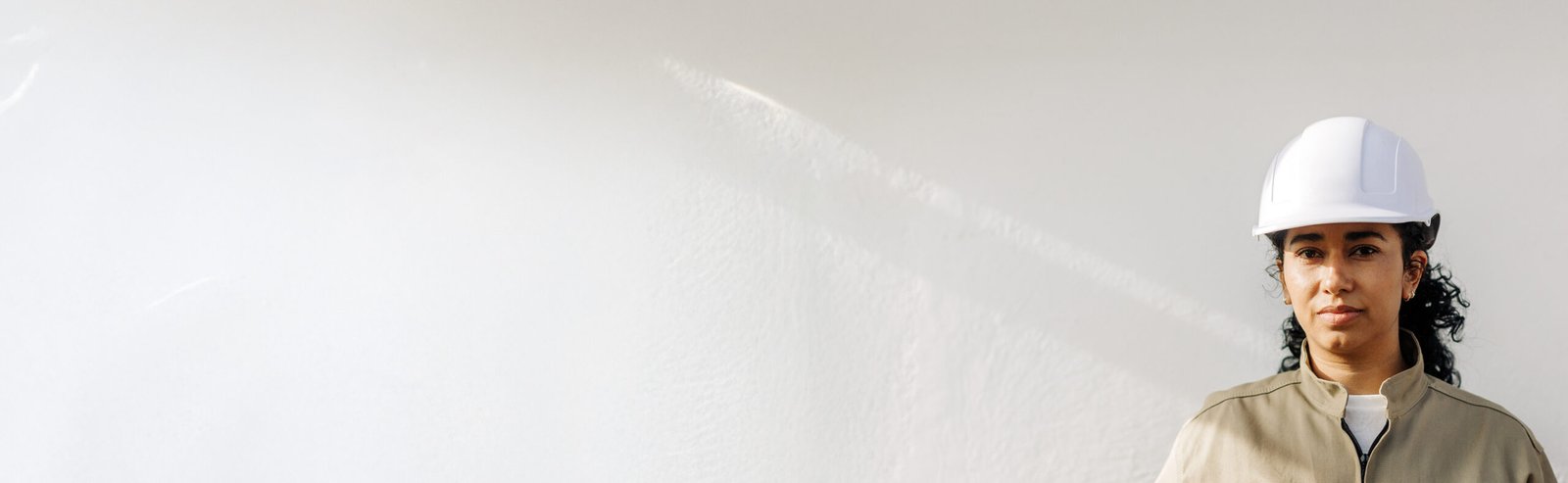 Image of a woman in a hard hat.