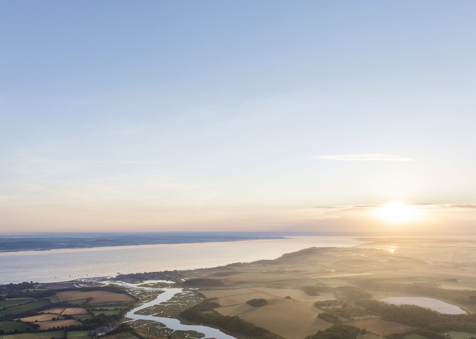 Landscape wide-shot of land split by a river.
